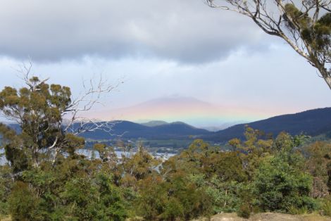 Rainbow and snow capped mountain