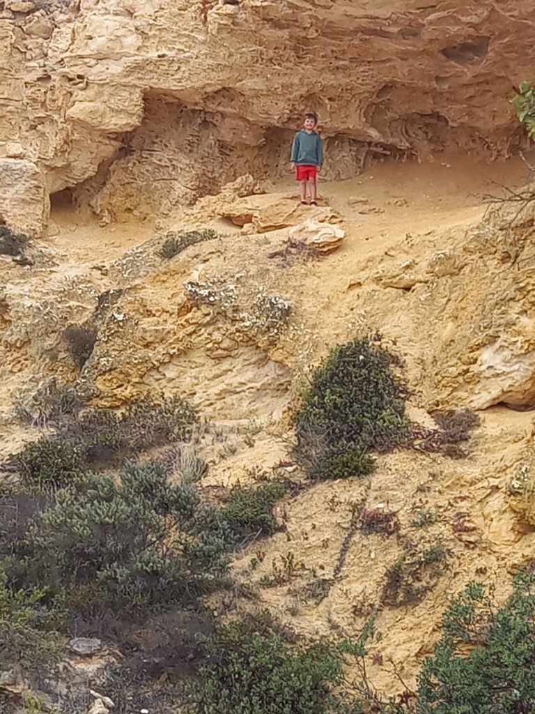 Hamish climbing the cliffs